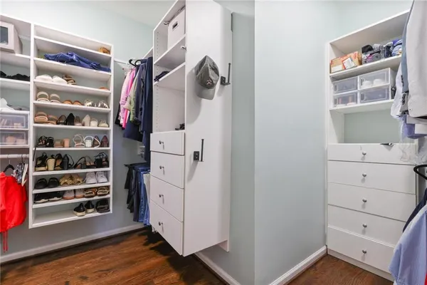 a view of walk in closet with empty racks