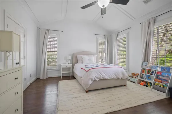 a spacious bedroom with a bed and a couch