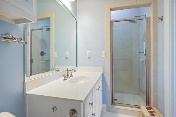 a bathroom with a sink a mirror and a shower