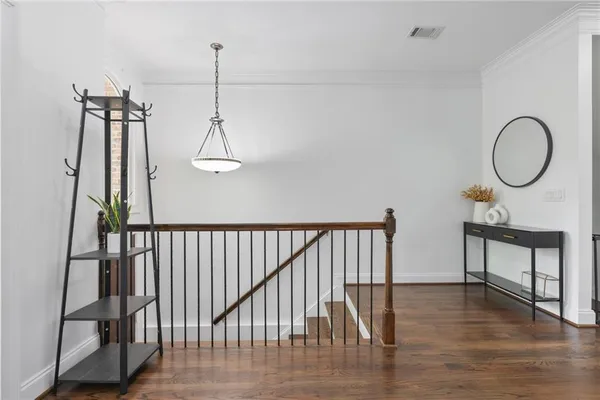 a view of a room with furniture and wooden floor