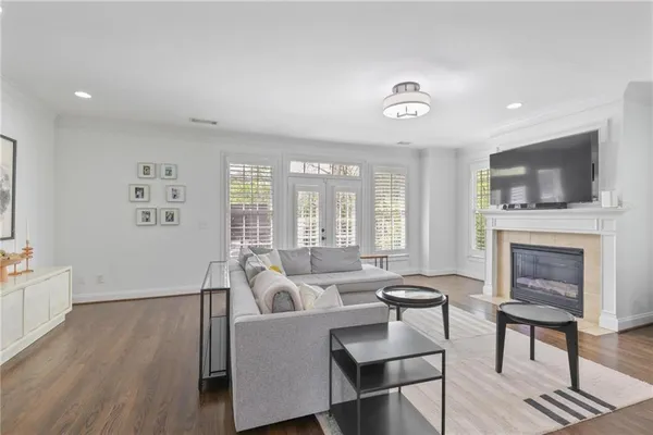 a living room with furniture a fireplace and a flat screen tv