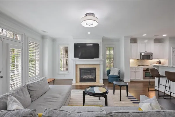 a living room with furniture a fireplace and a flat screen tv