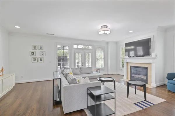 a living room with furniture a fireplace and a flat screen tv