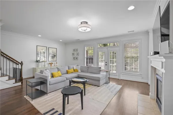 a living room with furniture a fireplace and a flat screen tv