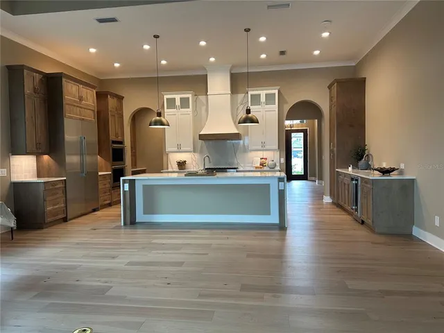 a view of kitchen with cabinets and wooden floor