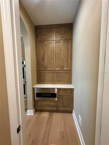 a view of room with wooden floor and staircase
