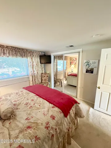 a bedroom with a large bed and a large window