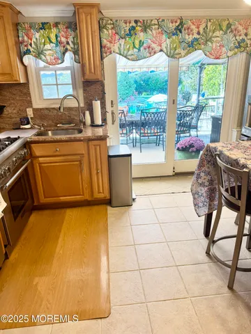 a kitchen with a stove a sink and a table