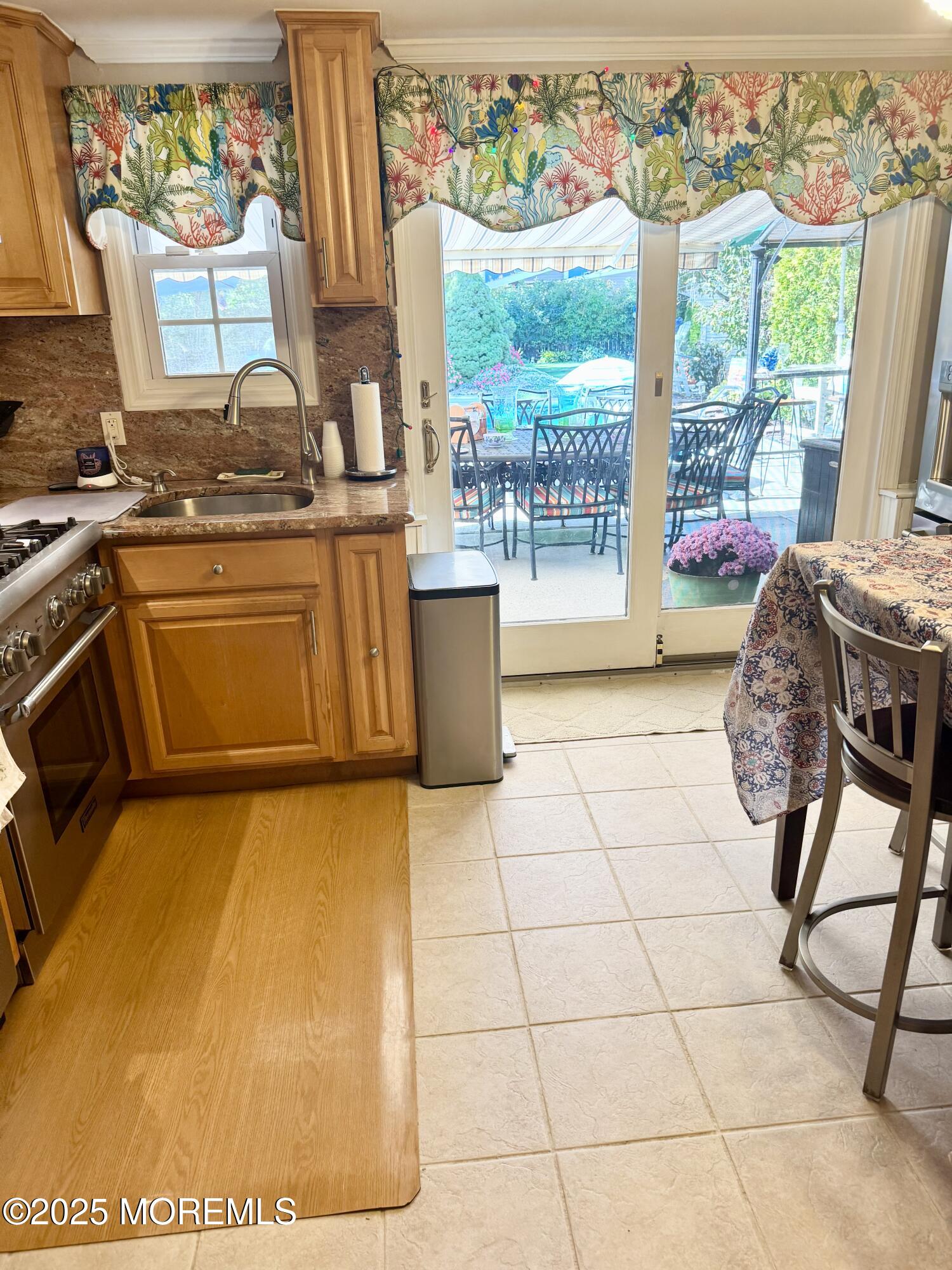 902 10th Street Union Beach, NJ 07735 - Photo 18 of 37 a kitchen with a stove a sink and a table