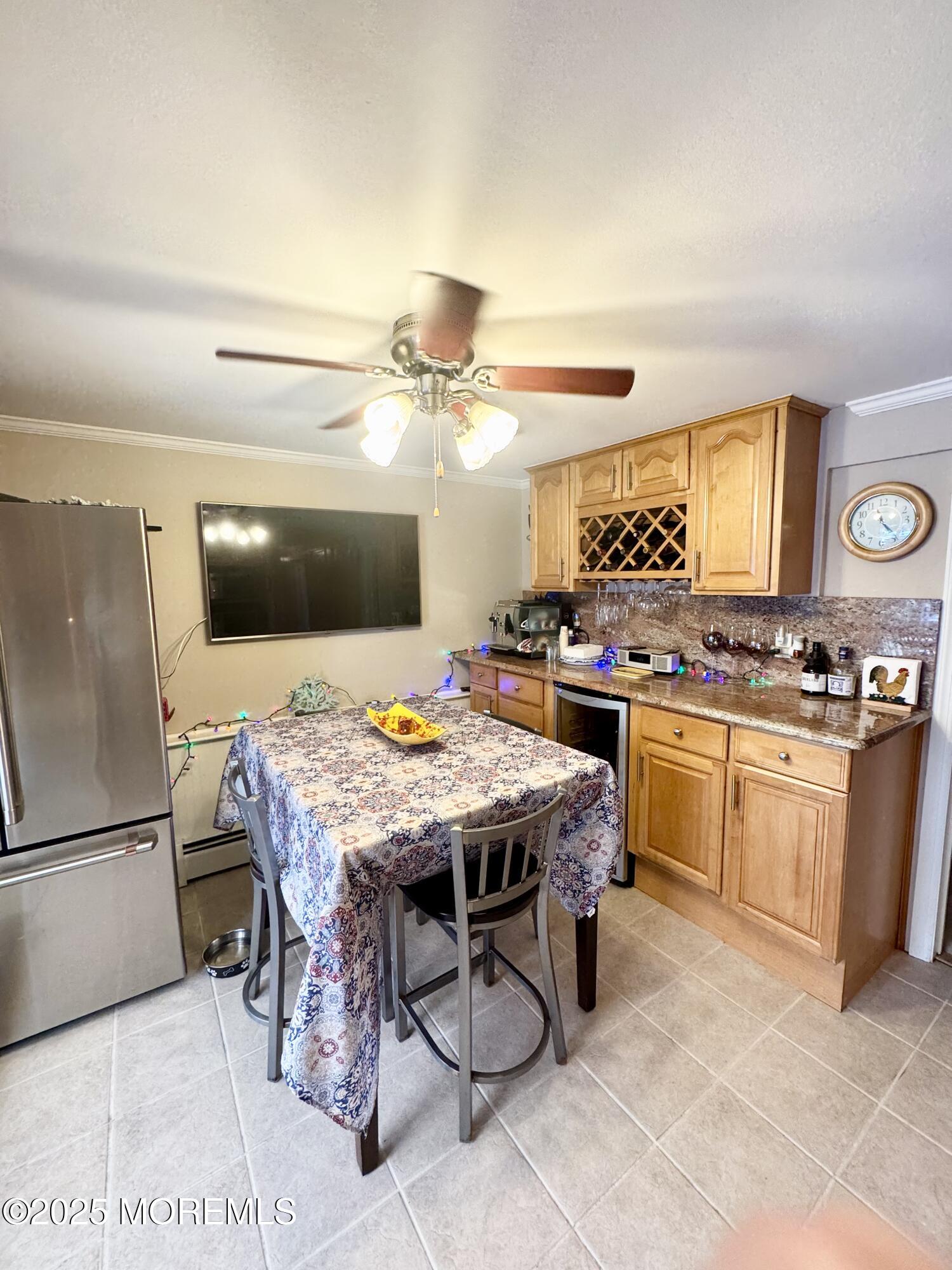 902 10th Street Union Beach, NJ 07735 - Photo 19 of 37 a kitchen with stainless steel appliances kitchen island granite countertop a table chairs sink and cabinets