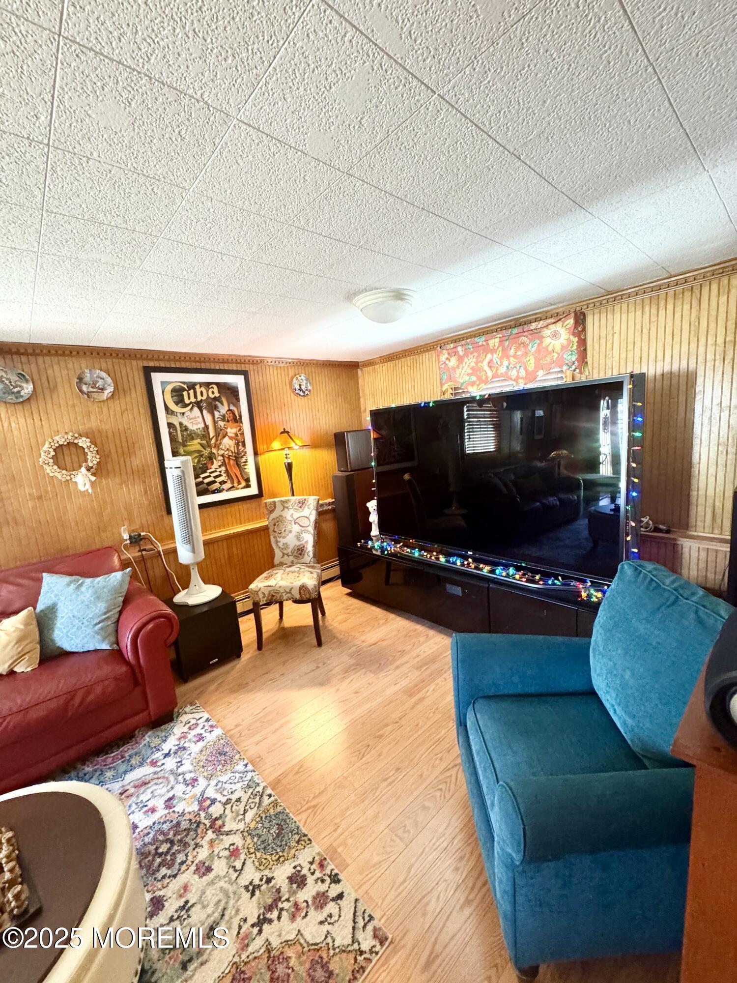 902 10th Street Union Beach, NJ 07735 - Photo 22 of 37 a living room with furniture and a flat screen tv