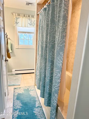 a view of a bathroom with a shower and a sink