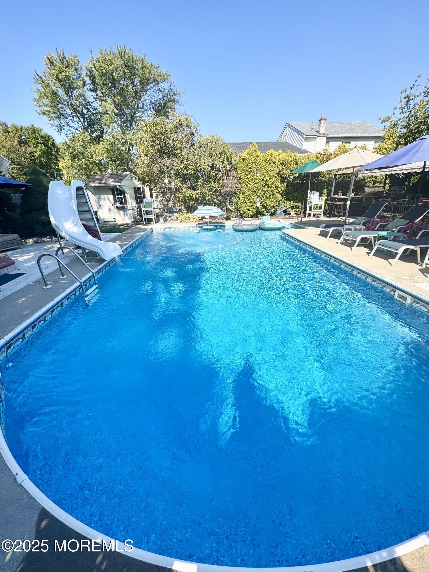 902 10th Street Union Beach, NJ 07735 - Photo 3 of 37 a view of outdoor space with swimming pool and patio