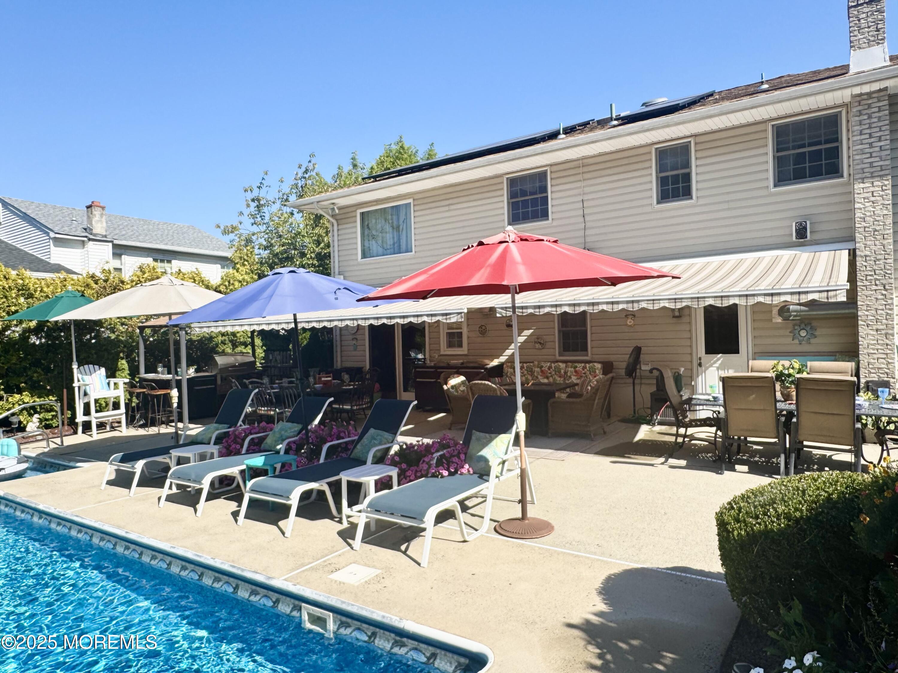 902 10th Street Union Beach, NJ 07735 - Photo 33 of 37 a patio with a table and chairs under an umbrella