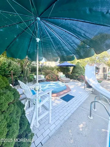 a view of a patio with table and chairs and potted plants