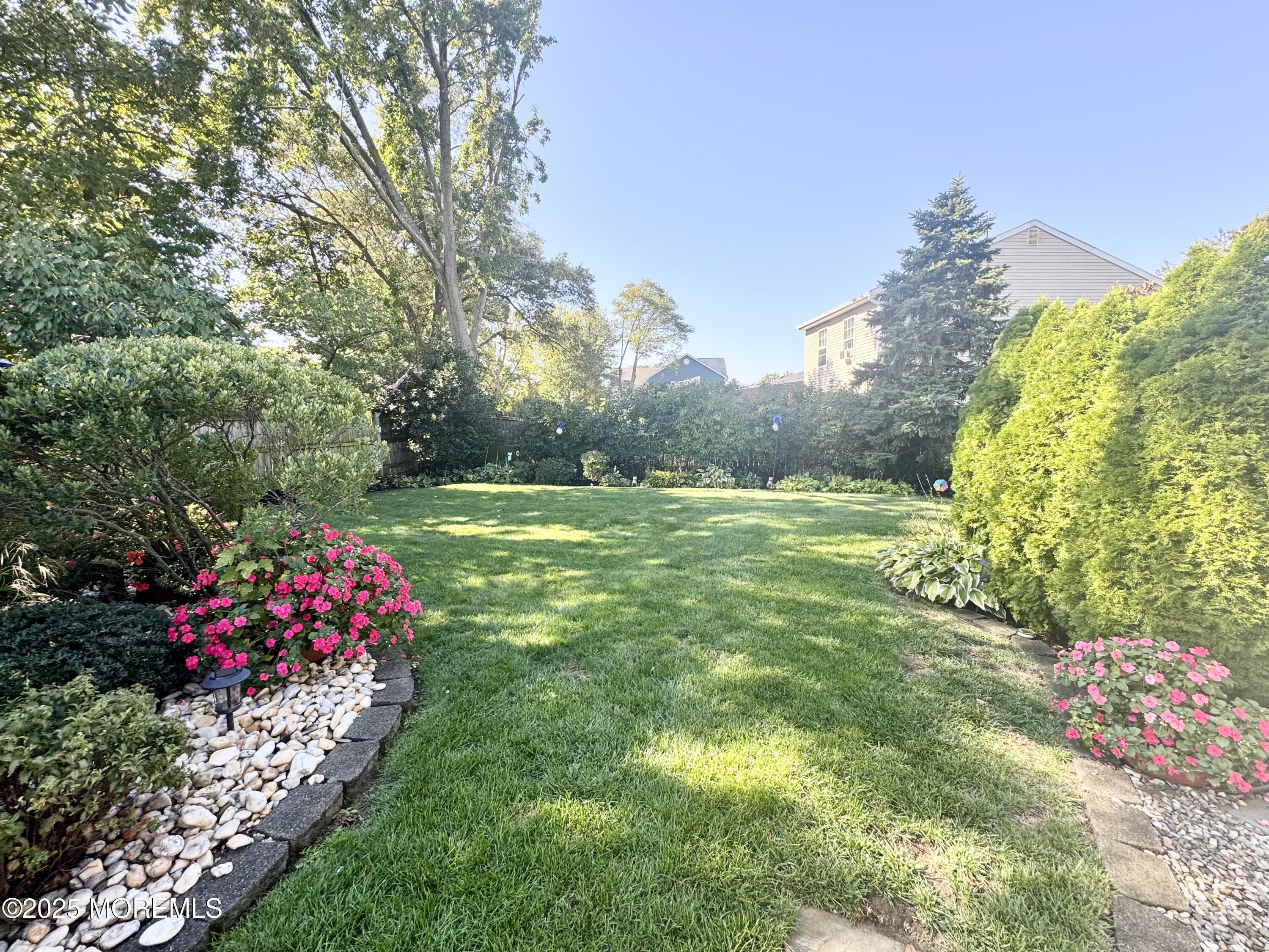 902 10th Street Union Beach, NJ 07735 - Photo 35 of 37 a view of a garden with flowers and large trees