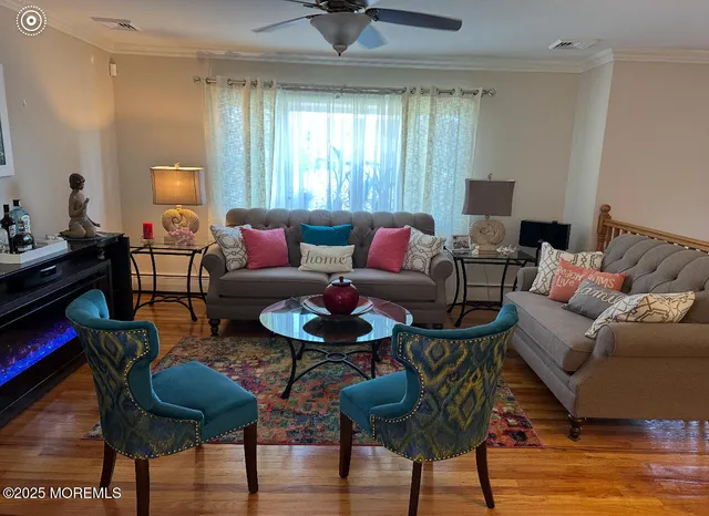 a living room with furniture and wooden floor