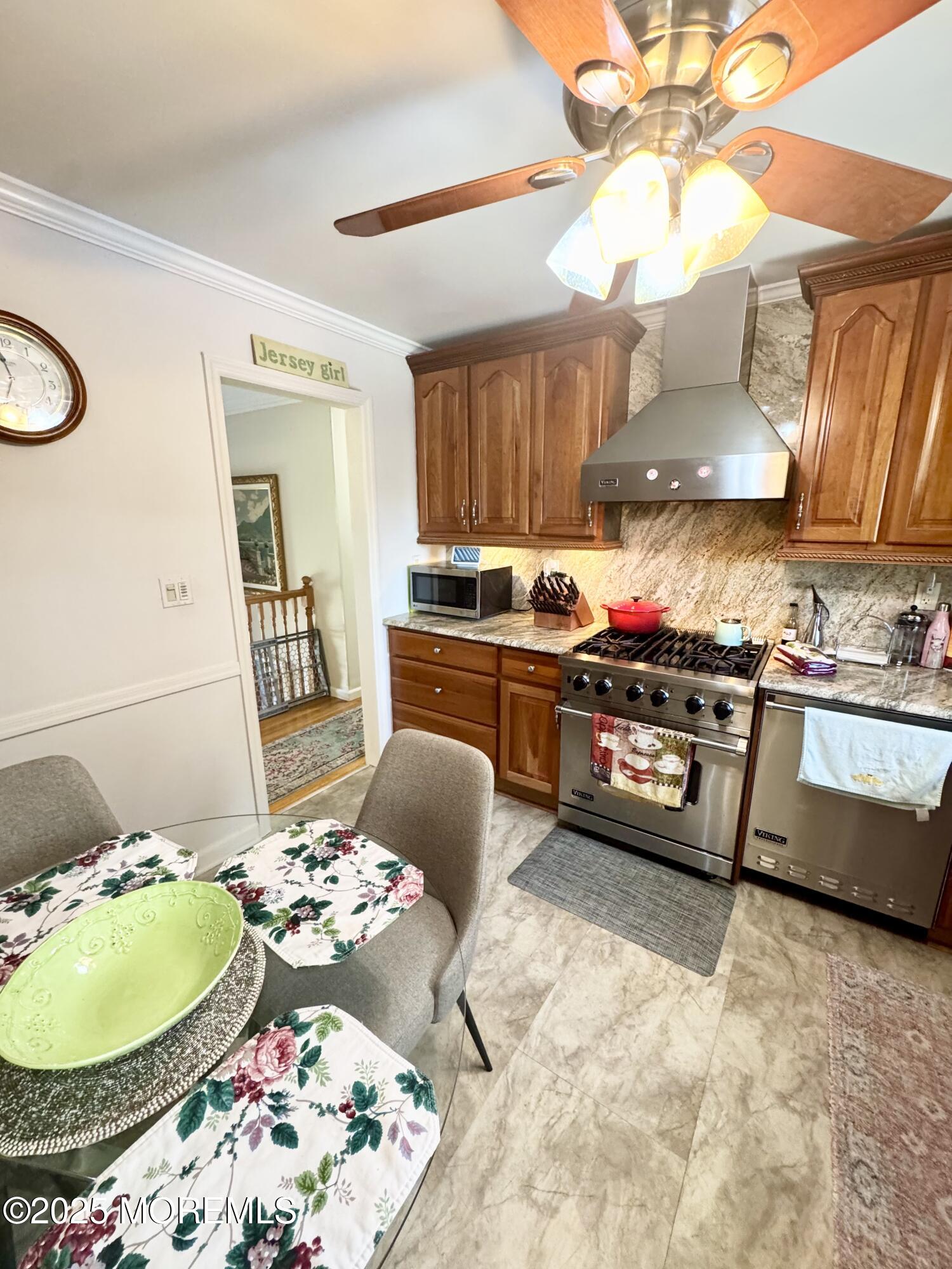 902 10th Street Union Beach, NJ 07735 - Photo 9 of 37 a kitchen with stainless steel appliances granite countertop a sink and a stove