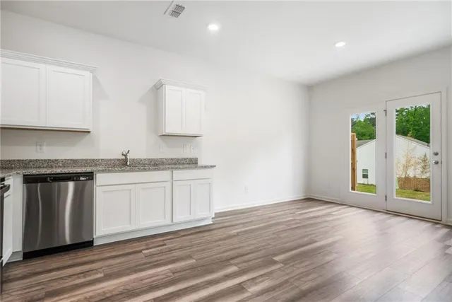 a kitchen with granite countertop a stove and a sink
