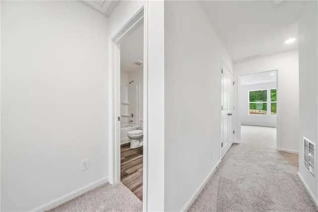 a bathroom with a sink a toilet and a large mirror