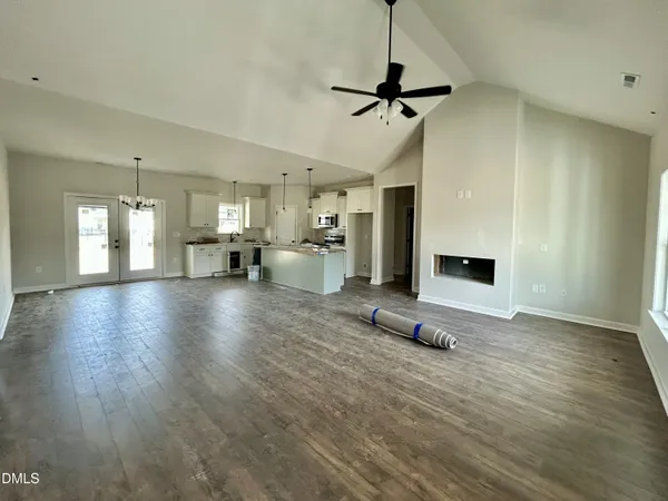 a view of a living room a kitchen and a wooden floor