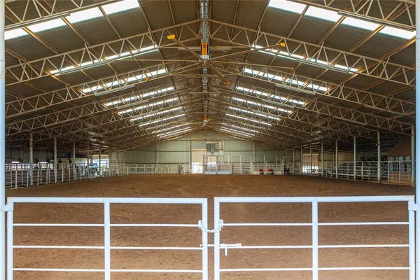 a view of a room with wooden floor and windows