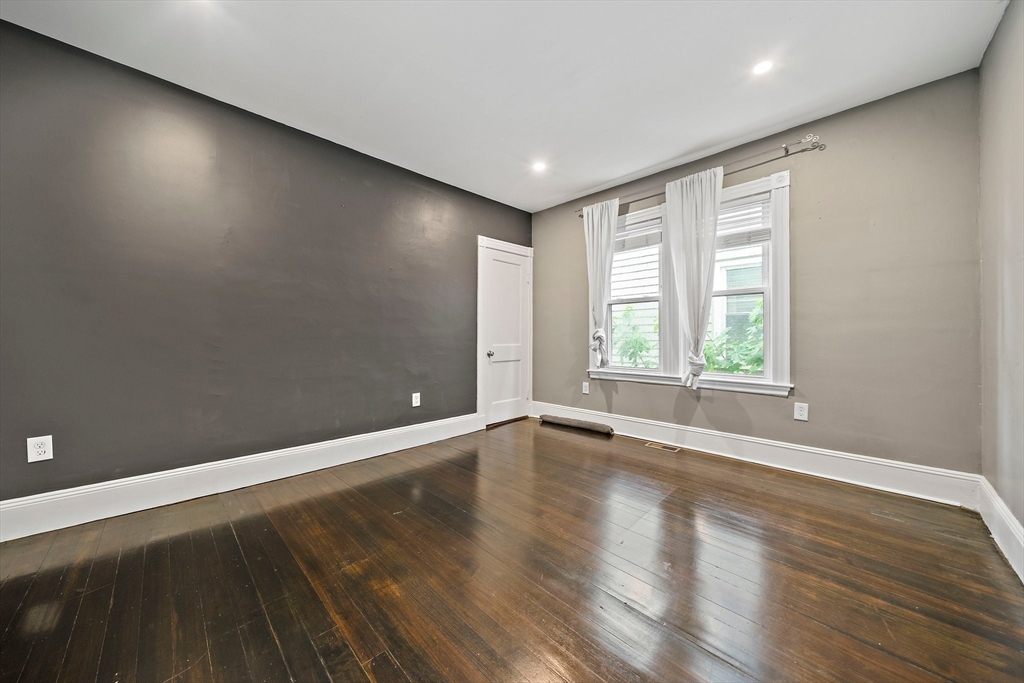 123 King Street, Unit 1 Boston, MA 02122 - Photo 18 of 24 an empty room with wooden floor and windows