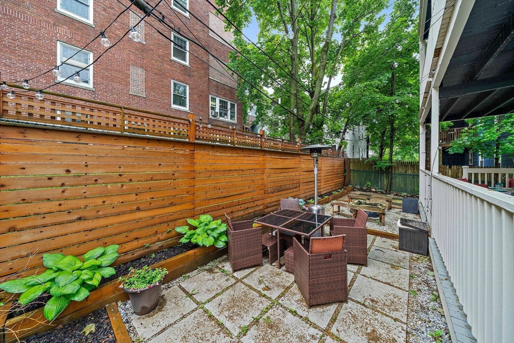 123 King Street, Unit 1 Boston, MA 02122 - Photo 22 of 24 a view of a patio with chair and table potted plants