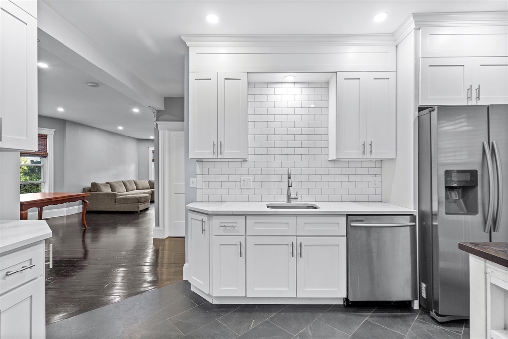 123 King Street, Unit 1 Boston, MA 02122 - Photo 4 of 24 a kitchen with a sink stainless steel appliances and cabinets