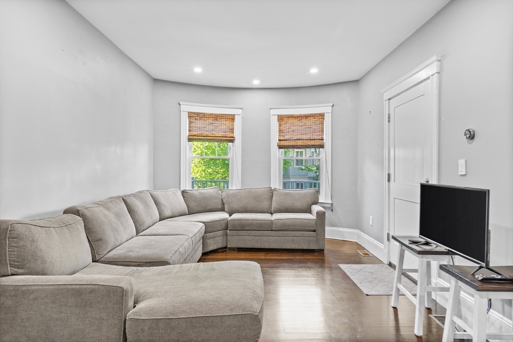 123 King Street, Unit 1 Boston, MA 02122 - Photo 7 of 24 a living room with furniture and a flat screen tv