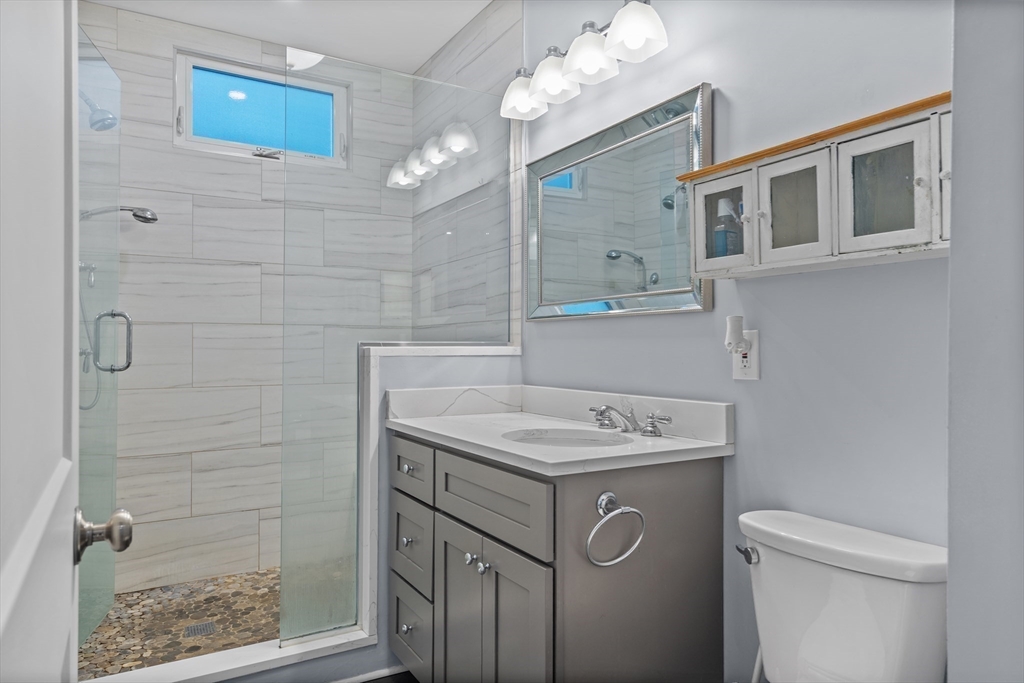 123 King Street, Unit 1 Boston, MA 02122 - Photo 10 of 24 a bathroom with a sink a toilet and shower