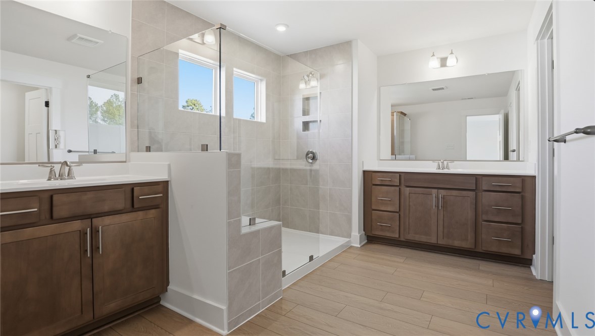 8900 Freebridge Road Chesterfield, VA 23832 - Photo 25 of 50 a bathroom with a granite countertop sink mirror and a bathtub