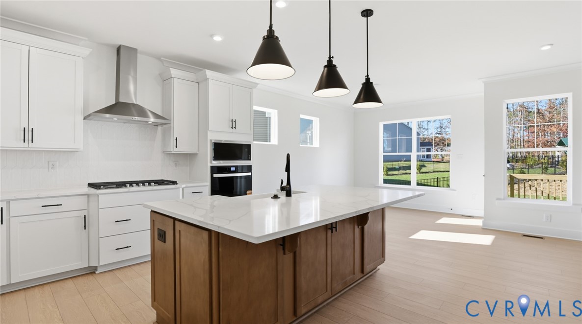 8900 Freebridge Road Chesterfield, VA 23832 - Photo 5 of 50 a kitchen with stainless steel appliances granite countertop a sink a stove a refrigerator and island with wooden floor