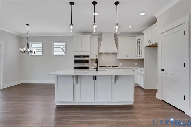a kitchen with kitchen island a sink stainless steel appliances and cabinets