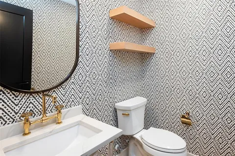 a white toilet sitting next to a bathroom sink