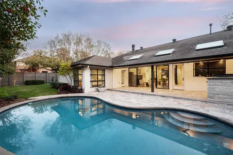 a house with swimming pool in front of it