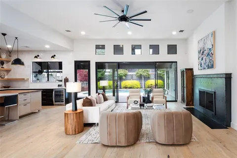 a living room with furniture a fireplace and a kitchen view