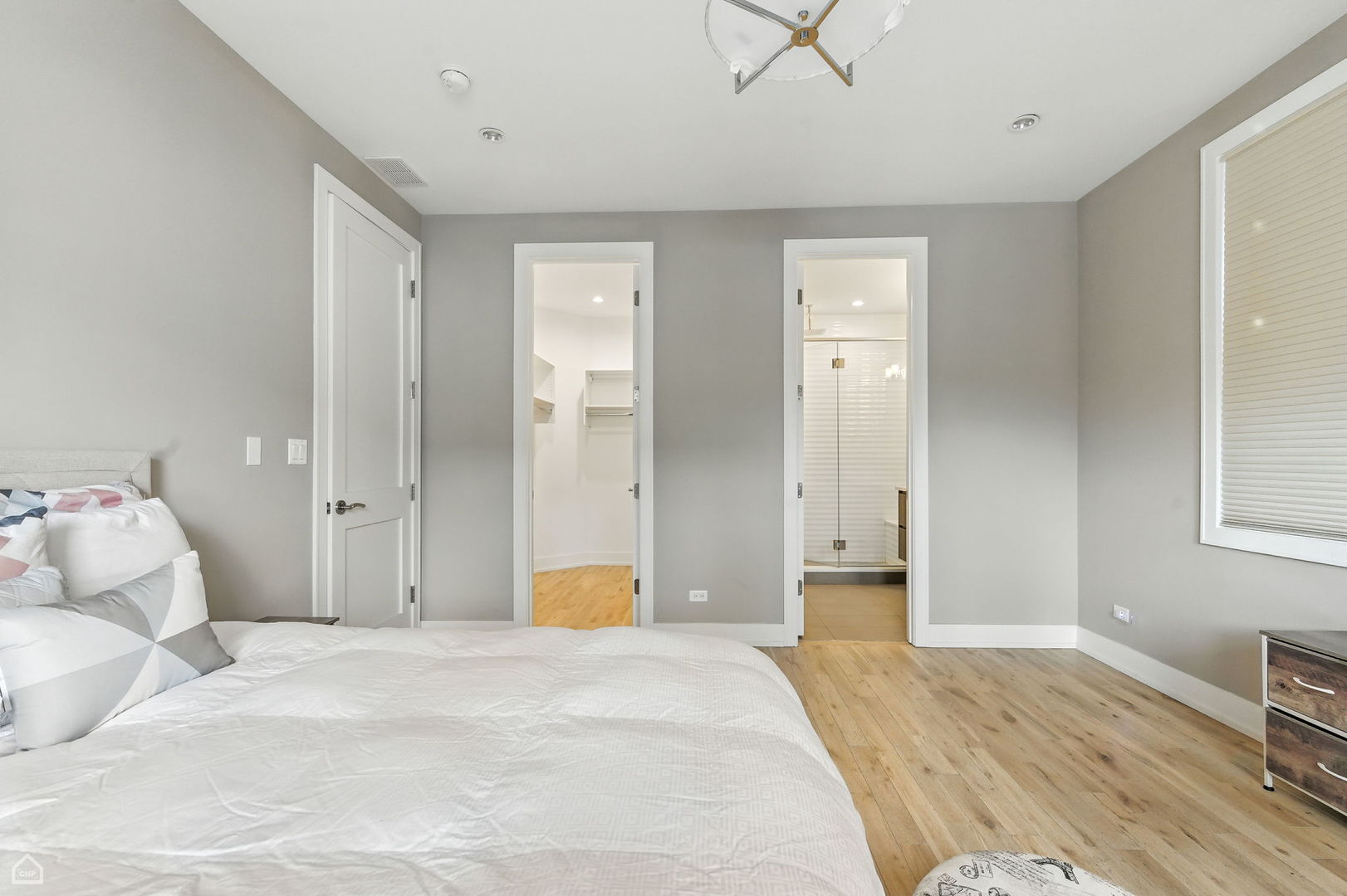 826 West Cullerton Street, Unit 2W Chicago, IL 60608 - Photo 18 of 23 a bedroom with a bed and a chandelier