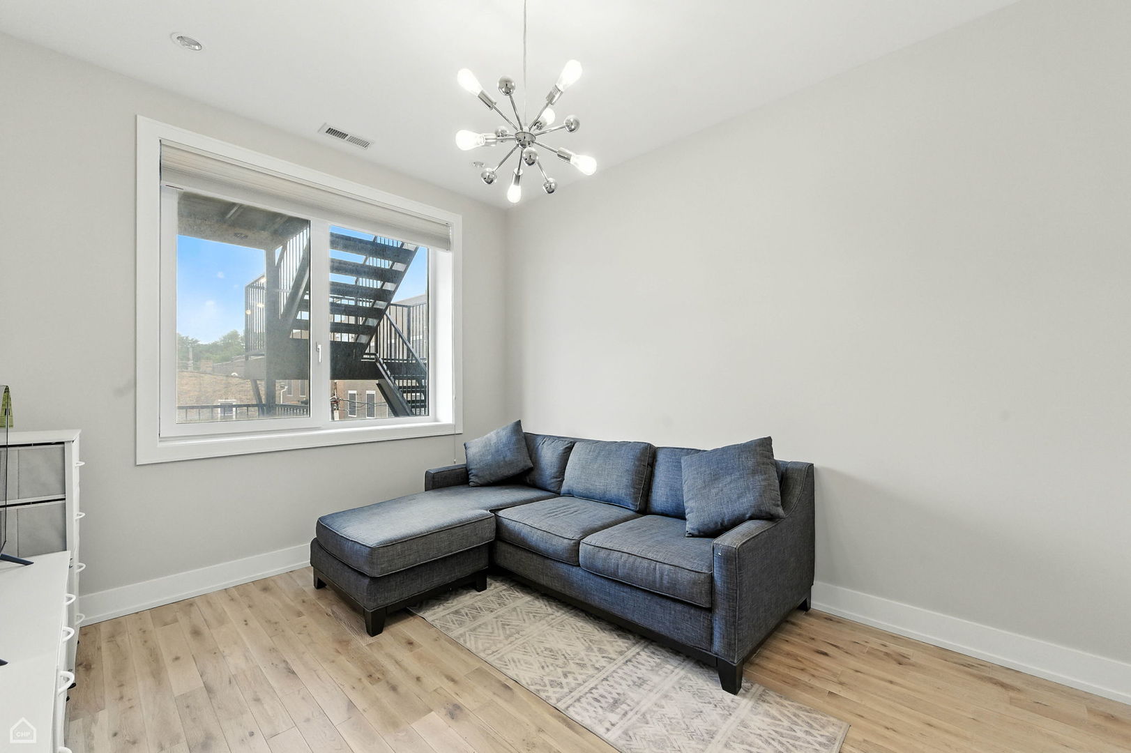826 West Cullerton Street, Unit 2W Chicago, IL 60608 - Photo 19 of 23 a living room with furniture and a window