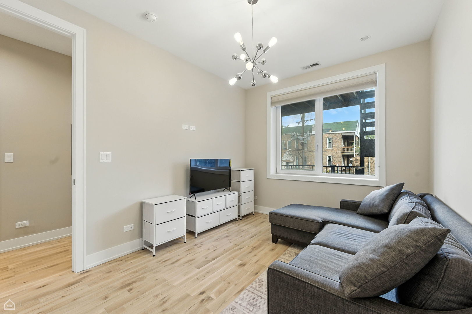 826 West Cullerton Street, Unit 2W Chicago, IL 60608 - Photo 20 of 23 a living room with furniture and a flat screen tv