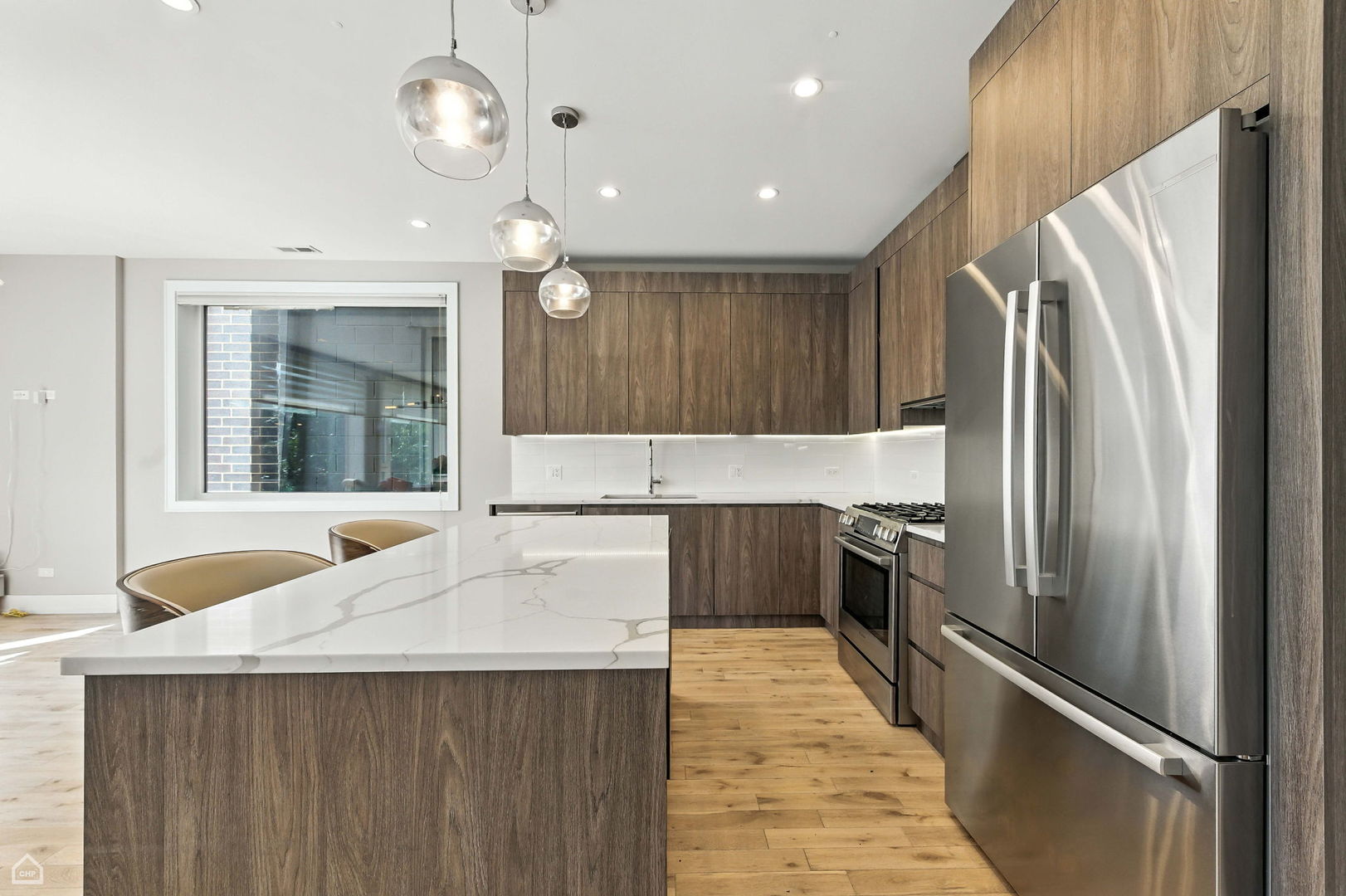 826 West Cullerton Street, Unit 2W Chicago, IL 60608 - Photo 5 of 23 a kitchen with stainless steel appliances a refrigerator and a sink