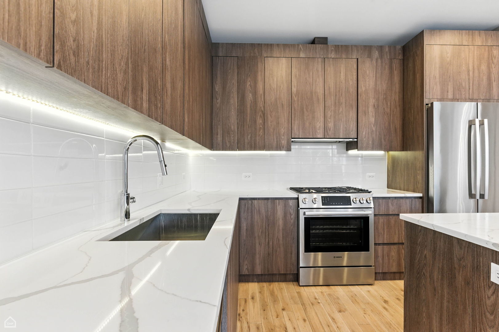 826 West Cullerton Street, Unit 2W Chicago, IL 60608 - Photo 6 of 23 a kitchen with wooden cabinets and a stove top oven