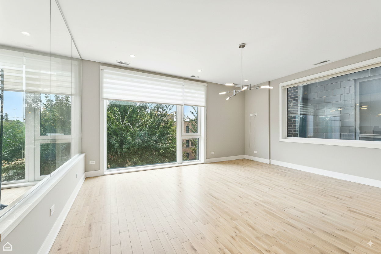 826 West Cullerton Street, Unit 2W Chicago, IL 60608 - Photo 10 of 23 a view of an empty room with wooden floor and a window