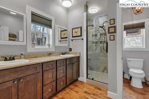 a view of a livingroom with wooden floor and a ceiling fan