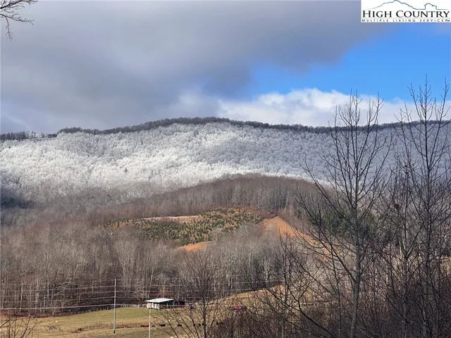 a kitchen with stainless steel appliances granite countertop a sink a stove a refrigerator and wooden floor