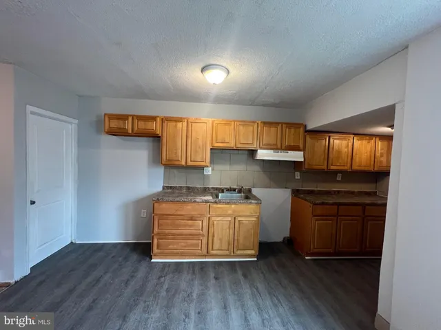 a kitchen with stainless steel appliances granite countertop a stove and cabinets