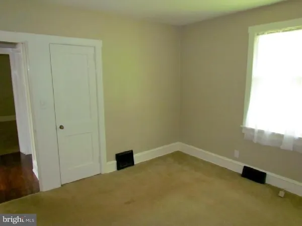 a view of an empty room and a window