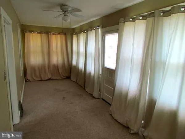 a view of a bathroom with shower and a tub