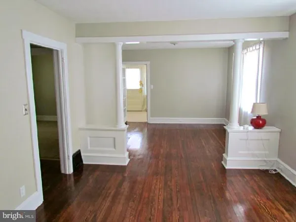 wooden floor in an empty room and a mirror