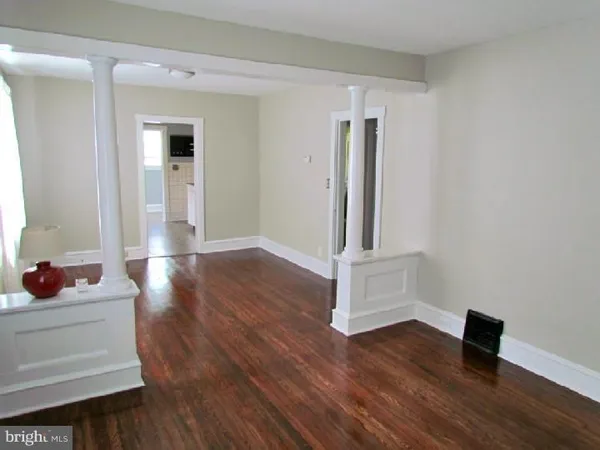 a view of an empty room and wooden floor